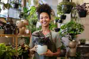 A cheerful plant store business woman at her shop